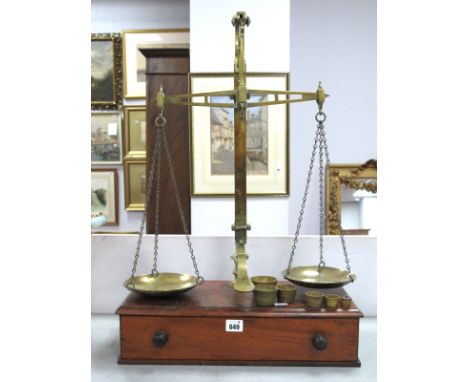Late XIX Century Brass Weighing Scales with Weights, mounted on a wooden base with single drawer, 69cm high.