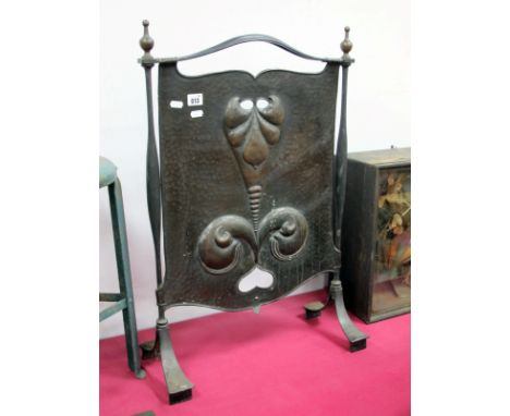 An Art Nouveau Copper and Iron Firescreen, the central rectangular panel cast with stylised scrolling motifs, 70cm high.