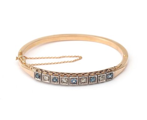 A 14 karat rose gold sapphire and diamond Victorian bangle. Featuring five light blue sapphires and four rose cut diamonds., 