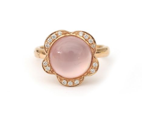 An 18 karat rose gold rose quartz and diamond ring by Bigli. Featuring a cabochon cut rose quartz surrounded by fifteen brill