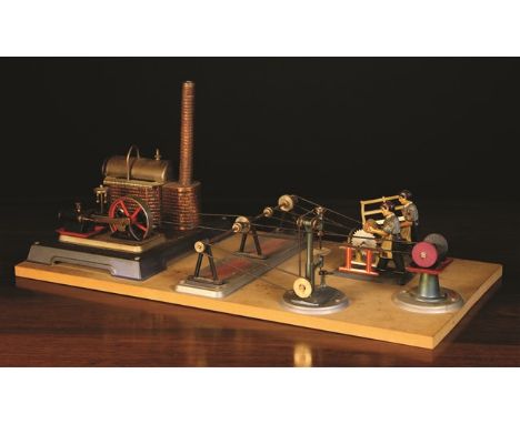 A Wilesco German Tin Plate Standing Steam Engine with workshop mounted on a board to include automated workmen hand operating
