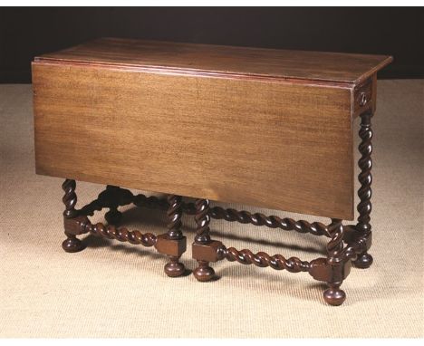 An 18th Century Red Walnut Writing Table with a drawer at each end and a single drop leaf raised on barleytwist gate-legs. Th