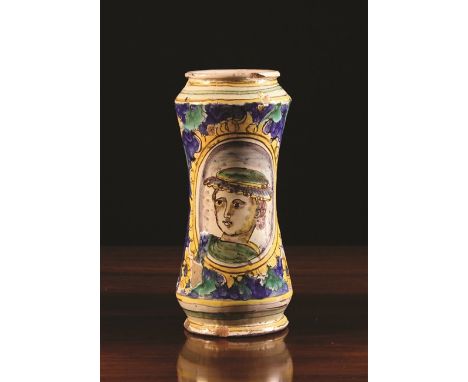 A 17th Century Waisted Albarello decorated in yellow, blue, green and manganese glaze with a portrait medallion picturing the