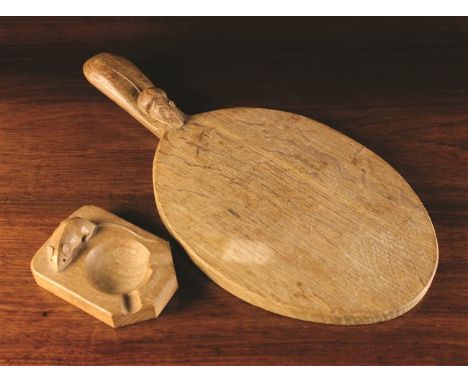 A Carved Oak 'Mouseman' Ashtray and an oak oval cheese board with trademark mouse to the handle. 