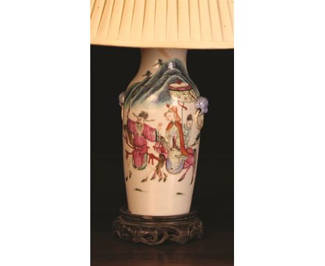 A Cantonese Table Lamp. The baluster body decorated in polychrome enamels with figures in landscape and mounted on a carved s