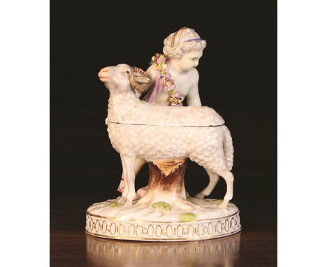 A 20th Century 'Meissen' Porcelain Ram Box (A/F). The ram mounted on an oval base with a young girl wearing a pink draped sas