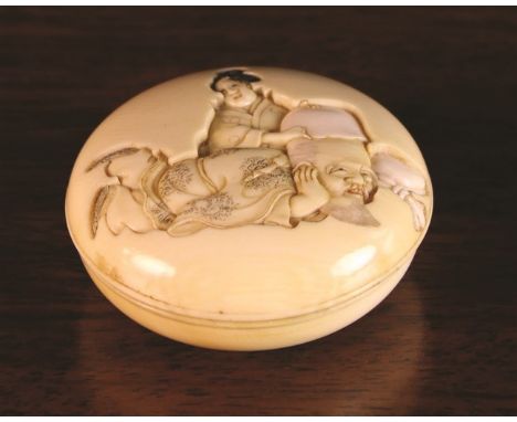 A 19th Century Carved Ivory Two-part Manju Netsuke depicting Fukurokuju with geisha to the lid and signed Koju to the base.