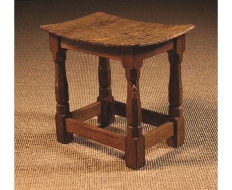 An Oak Mouseman Stool. The rectangular burr figured seat supported on a joined base of octagonal baluster legs on chamfered b