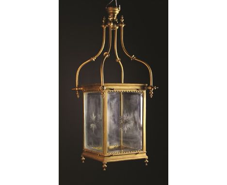 A Victorian Lantern. The four glass panel sides with star cut motifs and bevelled edges in a gold painted metal frame hung on