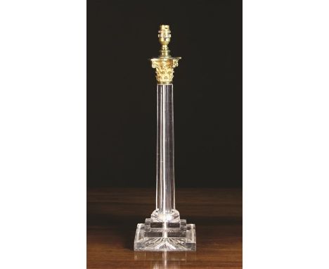 A Cut Glass Table Lamp. The tapered octagonal column leading down to a square stepped plinth with star cut base, surmounted b