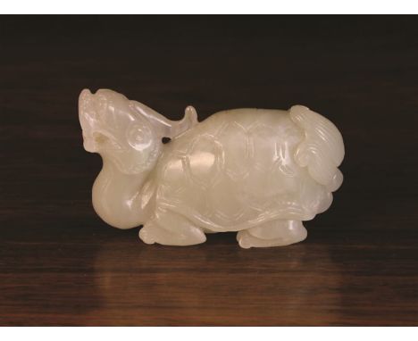 A Chinese Celadon Jade Carving of a Long Gui Dragon-Turtle, 1½ ins (4 cms) high, 2½ ins (6 cms) long.