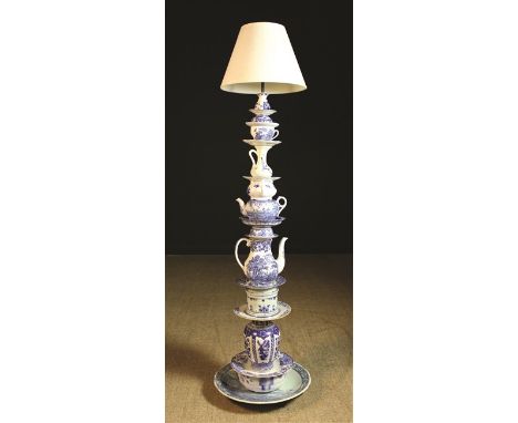 A Novelty Standard Lamp made from a stack of decorative blue & white pottery secured by a central rod and fitted with a cream