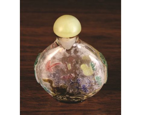 A Chinese Five Colour Glass Overlay Snuff Bottle, Yangzhou, Circa 1820-1880. The bottle carved with a cat, butterfy, rockwork