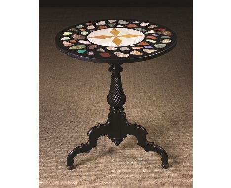 A Specimen Marble Topped Tripod Table. The round top inlaid with a compass star to the centre and irregular stone specimens o