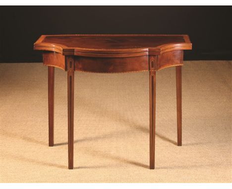 A Mahogany & Satinwood Cross-banded Fold-over Card Table inlaid with decorative stringing. The serpentine top on square taper