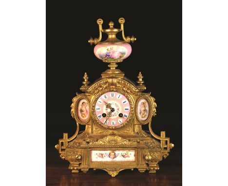 A 19th Century French Gilt Metal Mantel Clock with decorative porcelain insets painted with cherubs and flowers, and a porcel