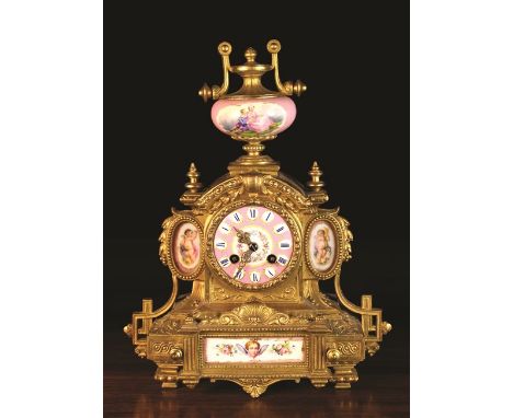 A 19th Century French Gilt Metal Mantel Clock with decorative porcelain insets painted with cherubs and flowers, and a porcel