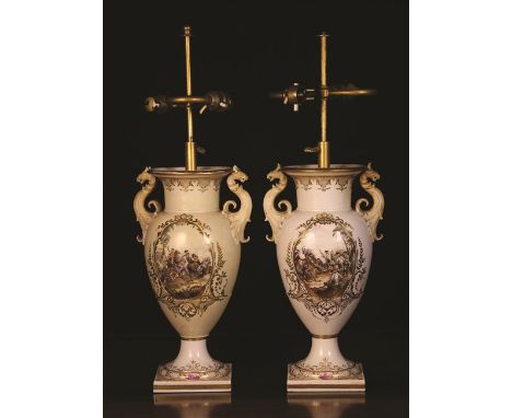 A Pair of Berlin Porcelain Lamp Vases. The cream glazed baluster bodies having griffin-headed foliate scroll handles and scen