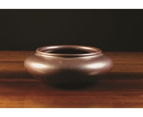 A Chinese Stoneware Bowl with thick aubergine-brown glaze and impressed Qianlong seal mark to the base 2¾ ins (7 cms) high, 7