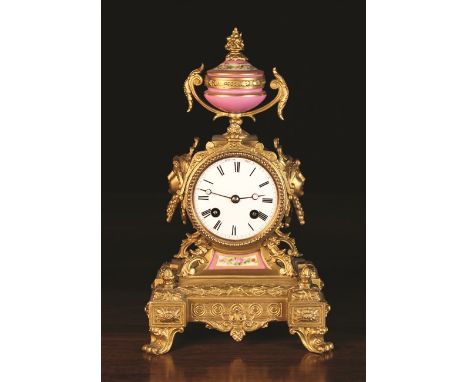 A Small 19th Century French Gilt Metal Mantel Clock with Sèvres style porcelain inset and urn finial decorated with flowers o