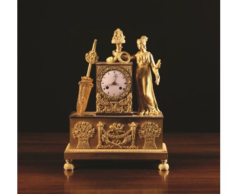 An Empire Ormolu Mantel Clock. The movement striking a bell with an enamelled dial set in a rectangular case embellished with