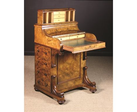 A Fine Victorian Figured Walnut Davenport. The 'piano top' opening to reveal a fitted interior of boxwood drawers over a pull