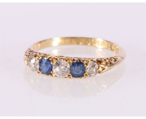 18ct gold diamond and sapphire five stone dress ring, the central round diamond approximately 0.21ct, ring size O, 3.6g 