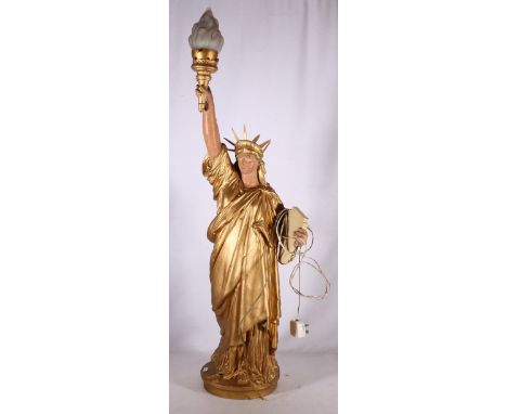 Metal table light in the form of the statue of liberty with opalescent flame shade, 100cm tall 