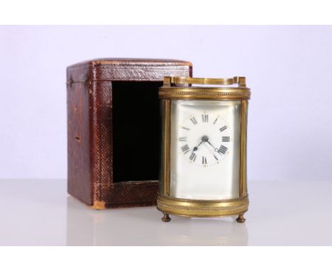 19th century French carriage clock of cylindrical form with enamel dial having Roman numeral chapter ring, 16cm tall with lea
