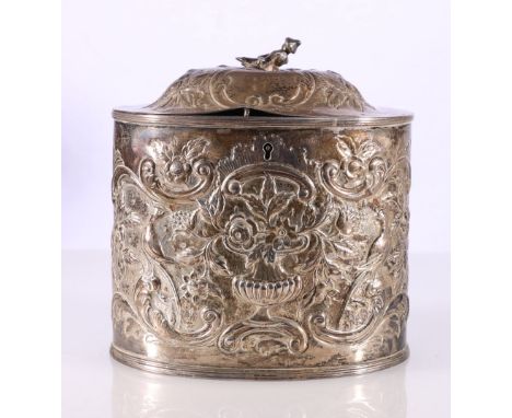 George III silver tea caddy with repousse urn of flowers and scroll decoration and figural finial, possibly by&nbsp;Thomas St