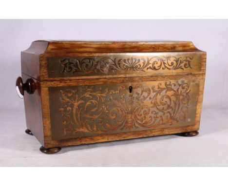 19th century rosewood tea caddy of sarcophagus form with fret type carved brass inlay, the hinged lid opening to reveal glass
