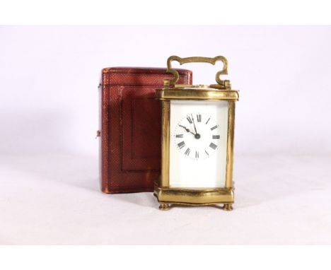 French carriage clock in serpentine case with further leather carrying case, 16cm tall 