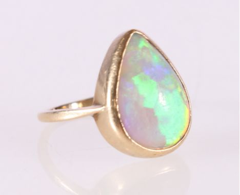 Unhallmarked yellow metal dress ring set with cabochon pear shaped opal, ring size P, 3.7g Good condition 