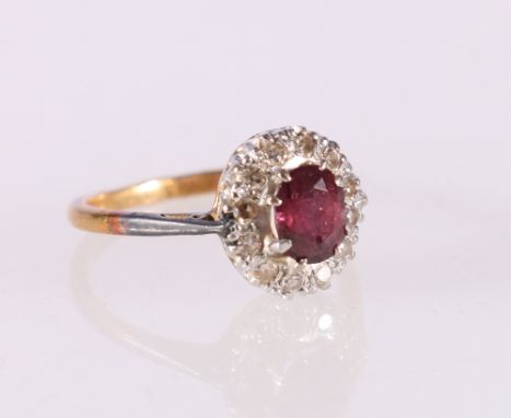 18ct yellow gold diamond and ruby cluster ring, the central faceted ruby encircled by twelve round diamonds, ring size L, 3.2