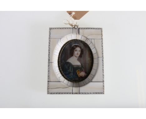 An ivory framed portrait miniature on ivory of a women holding a prayer book, signature to the lower right , 13.5cm x 11cm. 