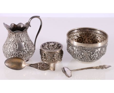 Thai Siamese silver spoon and pusher with deity finials, white metal box and cover, a white metal cream jug and a white metal