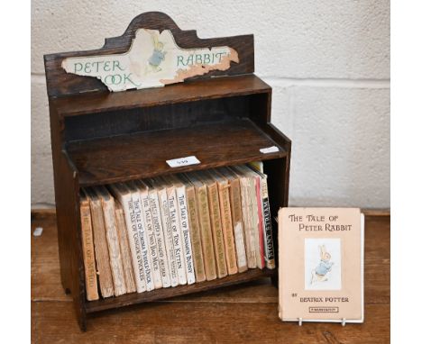 A selection of vintage Beatrix Potter books (a/f), in oak bookcase 