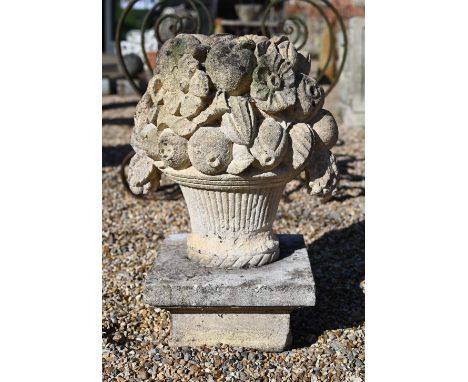 A weathered cast stone garden basket of fruit form finial, 40 x 30 x 60 cm high