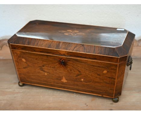 A large 19th century inlaid rosewood sarcophagus tea caddy with two bone-handled covered inner compartments and brass ball fe