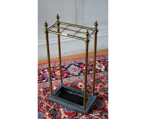 An antique six division brass stick-stand with cast iron base, 32 cm x 18 cm x 64 cm h 