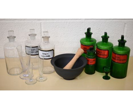 Seven antique/vintage apothecary bottles - all named to/w three glass conical measures, an eye-bath and a pestle and mortar (