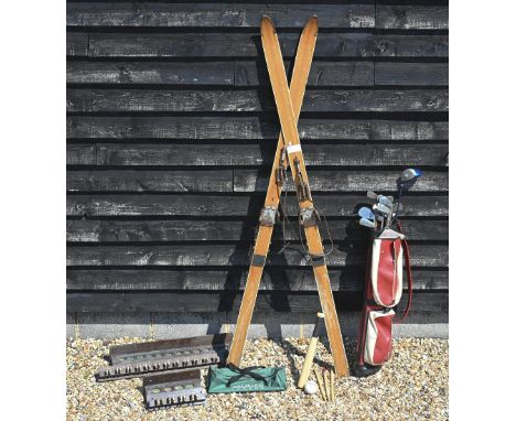 A pair of vintage wooden skis, 214 cm to/w to hickory-shafted niblicks and other golf clubs, two snoooker cue-stands (wall cl