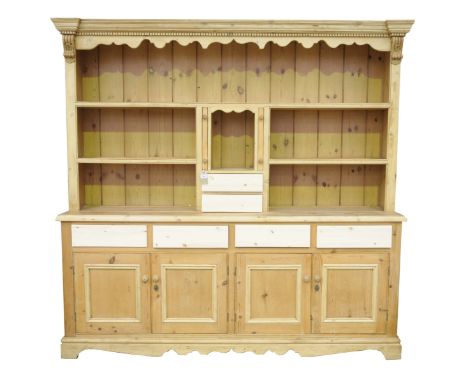 A substantial pine kitchen dresserWith a moulded dentil cornice and shaped frieze above an arrangement of one long and two sh