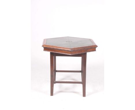 An early 20th Century rosewood card tableThe leather inset hexagonal moulded top with a central well and cover, the table rai