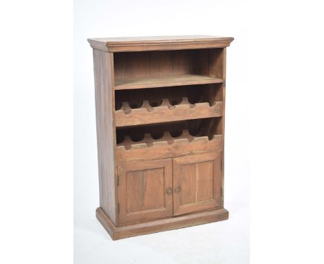 A rustic hardwood wine rackWith a rectangular top above a single shelf and two bottle rails over two cupboard doors and a pli