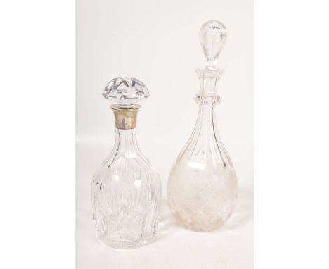 A silver mounted decanter and a second decanterThe cut glass mallet shaped decanter with a mushroom stopper and star cut base