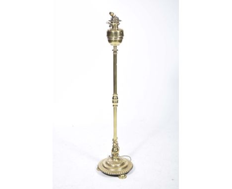 A Victorian brass lamp standardLater converted with a domed brass reservoir on a telescopic cylindrical shaft, mounted on a b