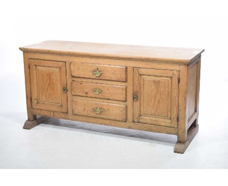A 19th Century pine kitchen dresser baseThe rectangular moulded top above three central drawers each with  brass swan neck ha