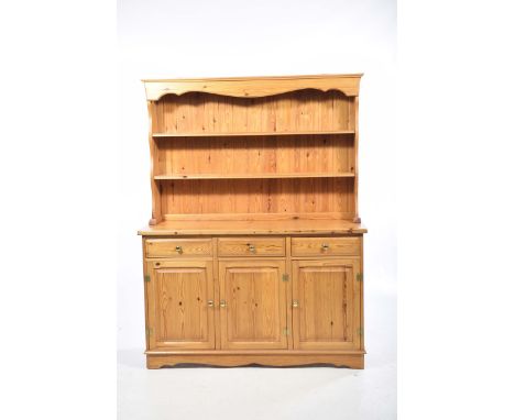 A modern pine kitchen dresserThe high back with two enclosed shelves above a rectangular moulded top, three frieze drawers an
