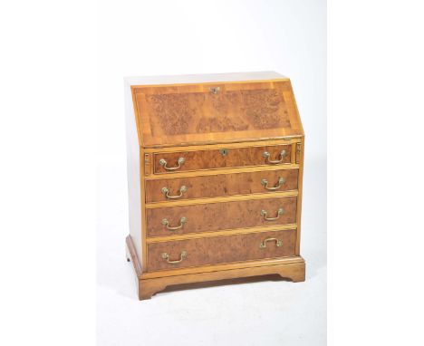 A reproduction yew wood bureauIn the Georgian style with a fall front over four long drawers brass swan neck handles and brac